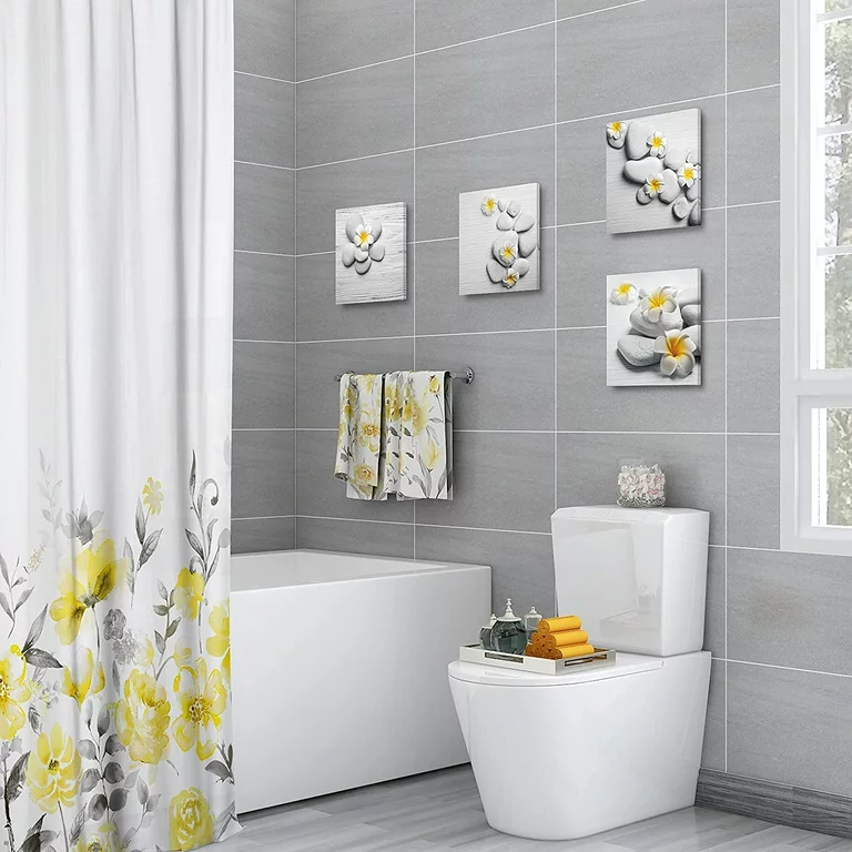 art pieces hung on grey walls in a bathroom white bathtub white shower curtain with yellow flowers