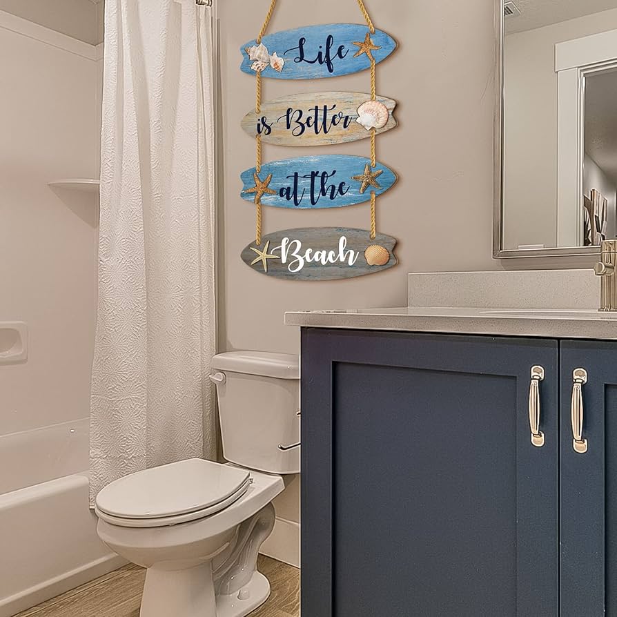 A view of a bathroom with a pennant framed over the toilet