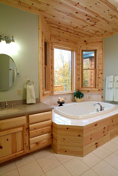 A view of a bathroom with knotty pine tongue and groove woode paneling all over