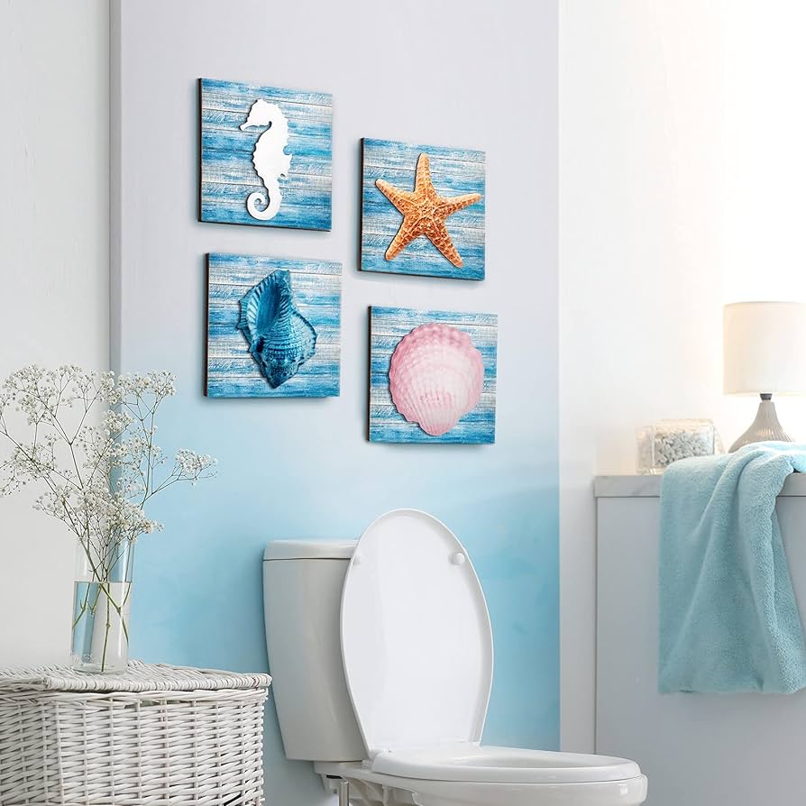 A view of a blue and white bathroom space with shells and starfish pictures hanging above the toilet