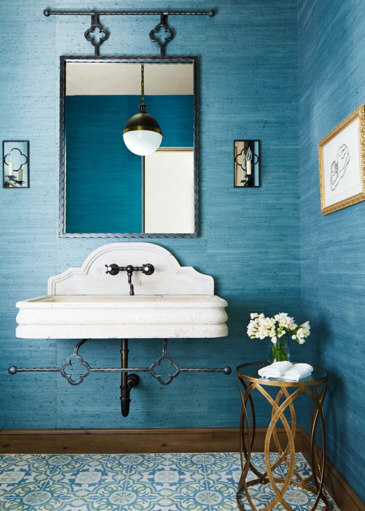 A view of a blue bathroom with a white trendy sink