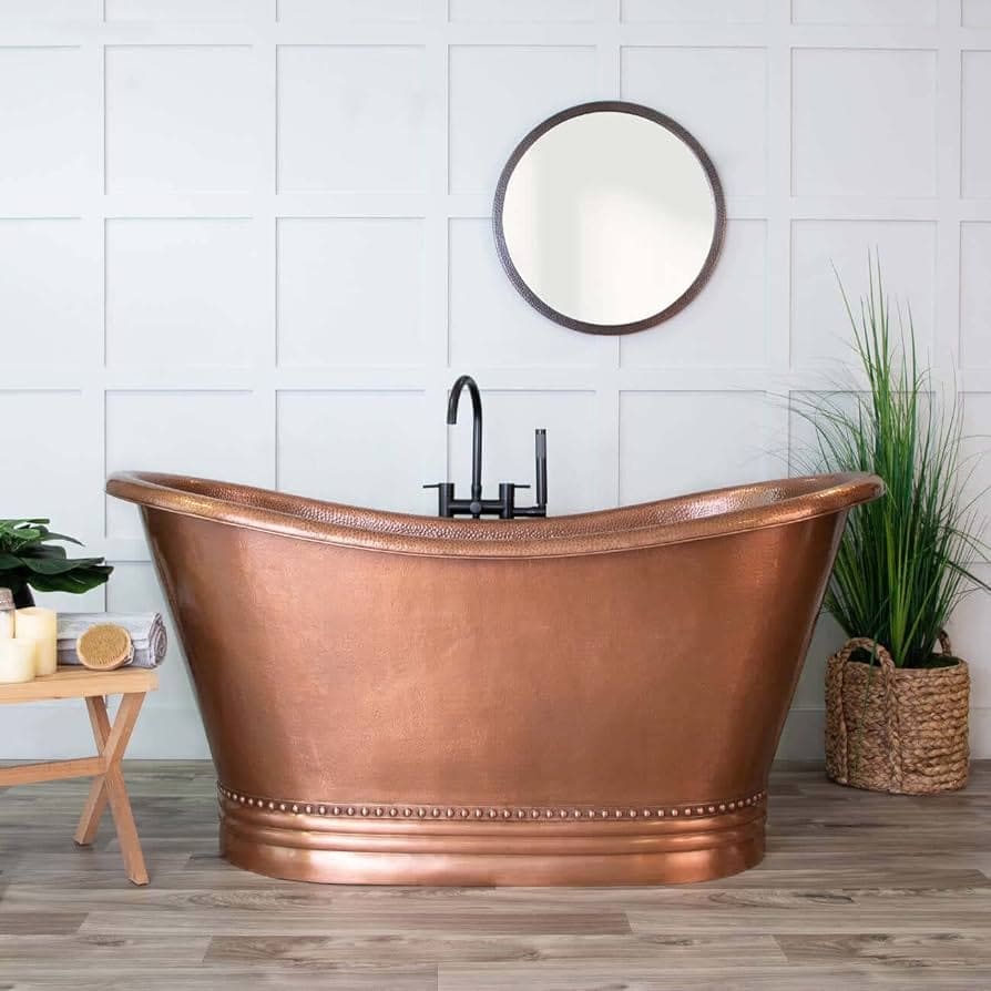 A view of a copper bath tub with a round mirror above