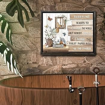 A view of a pastoral painting over a tub in a rustic bathroom