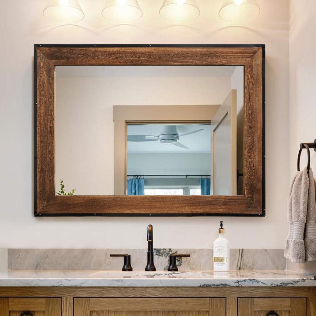 A view of a sqaure wooden mirror attached over a sink in a bathroom