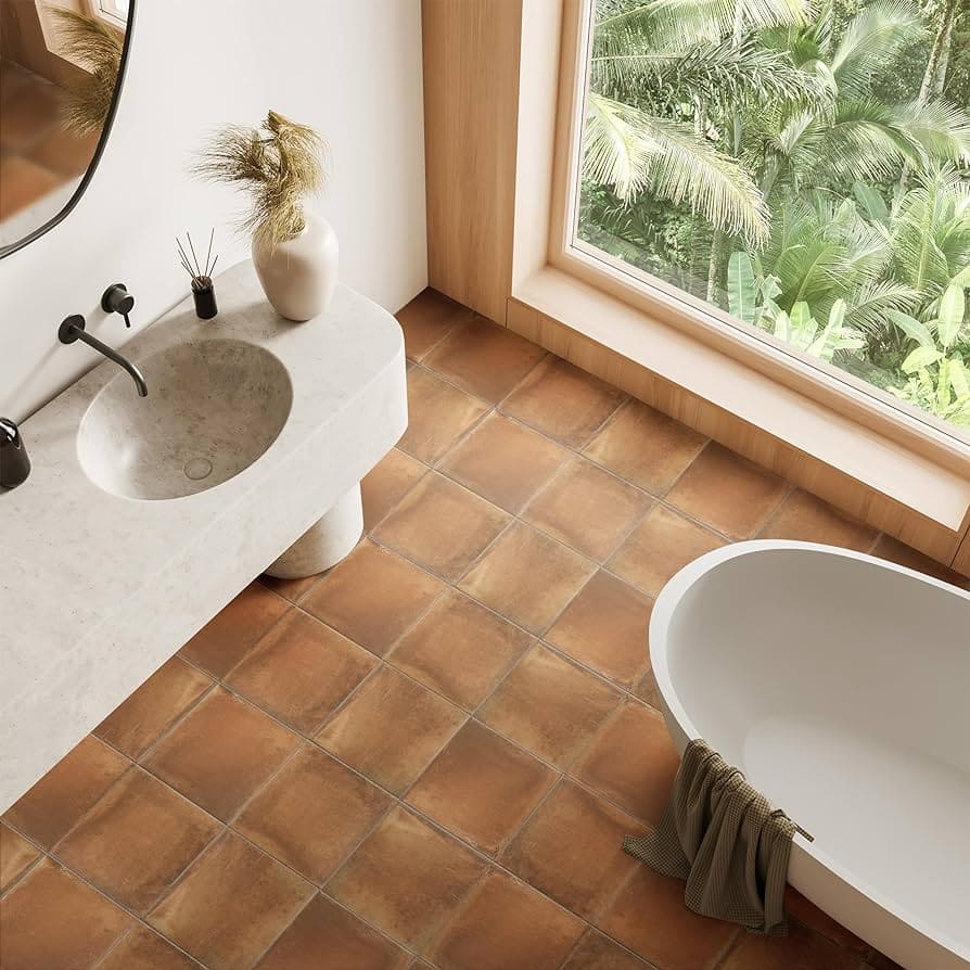 A view of rustic bathroom tiles with a sink and a window view