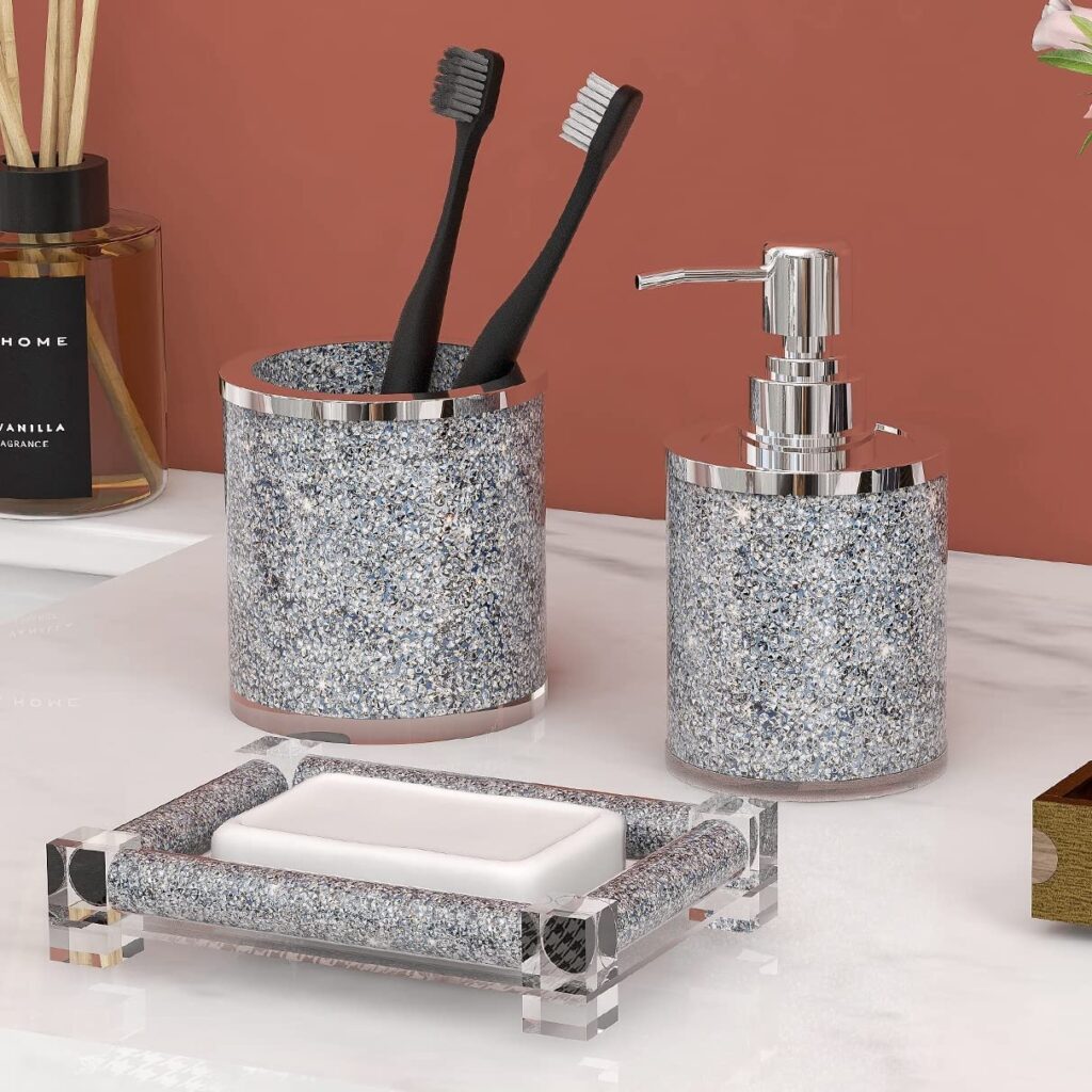 A view of shiny toothbrush holder and a soap holder along with a handwash bottle