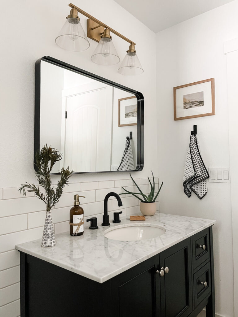 different decorative items set on wall of bathroom lighting fixtures black framed mirror black vanity