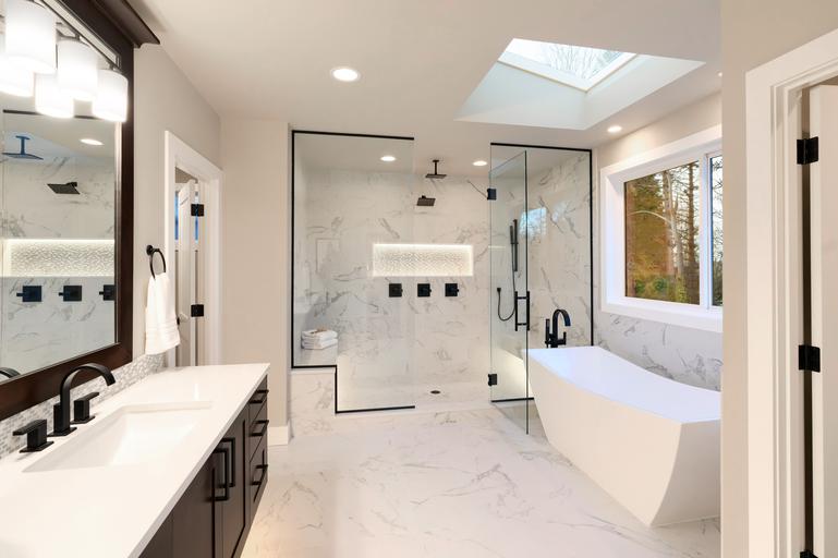 master bathroom with windows for natural light flow a big bathrub vanity and mirror