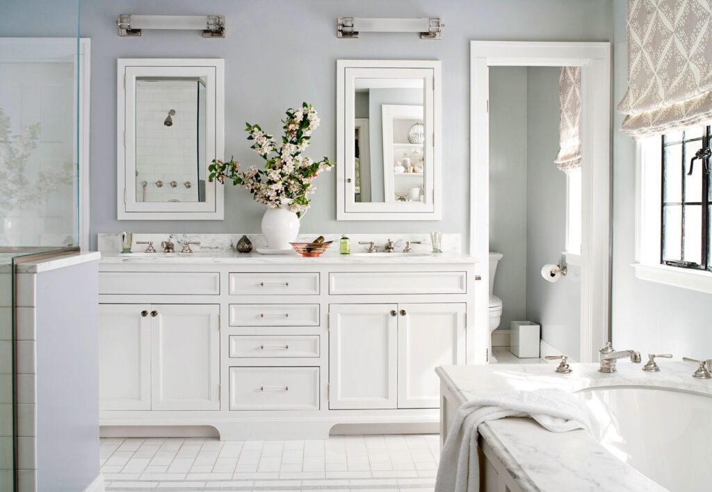 neutral color palette in a bathroom vase with flowers white big vanity mirrors fixed fixtures