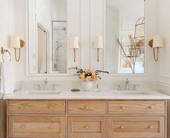 statement lamps in a bathroom mirrors wooden vanity