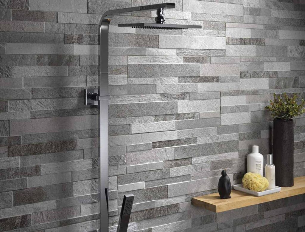 textured gray tiles in bathroom black shower decorative pieces placed on side with toileteries