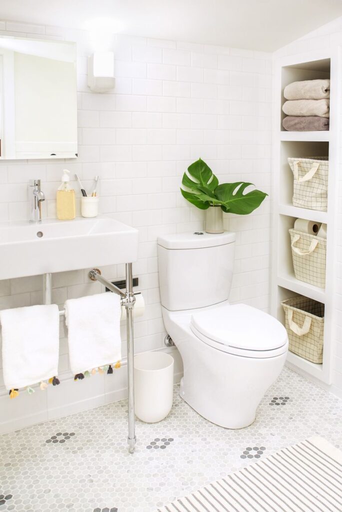 vertical storage shleves in a bathroom plant and towels