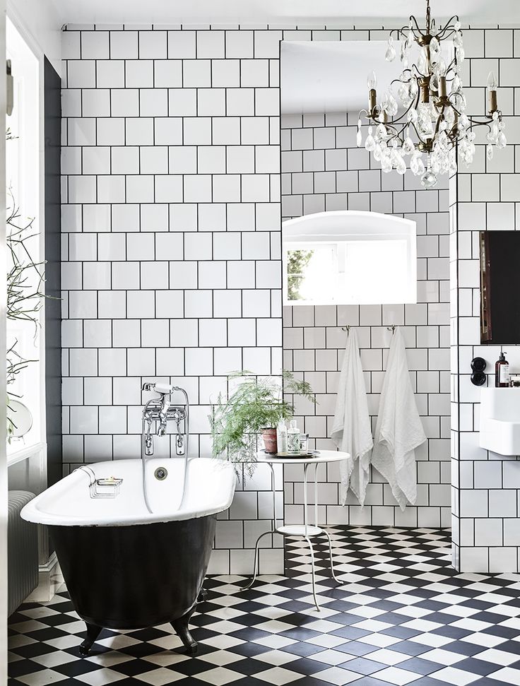 A view of a bathroom with Black and White Checkered Board Floor