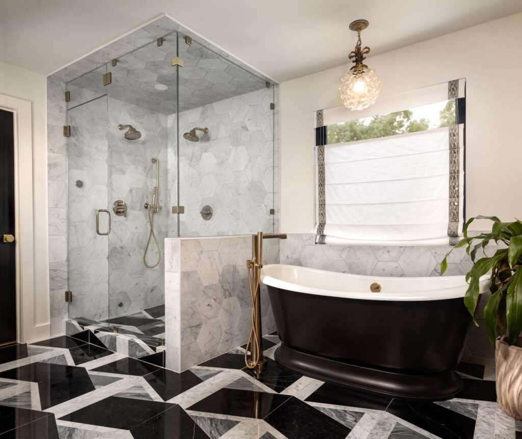A view of a black bathroom tile with a black bath tub