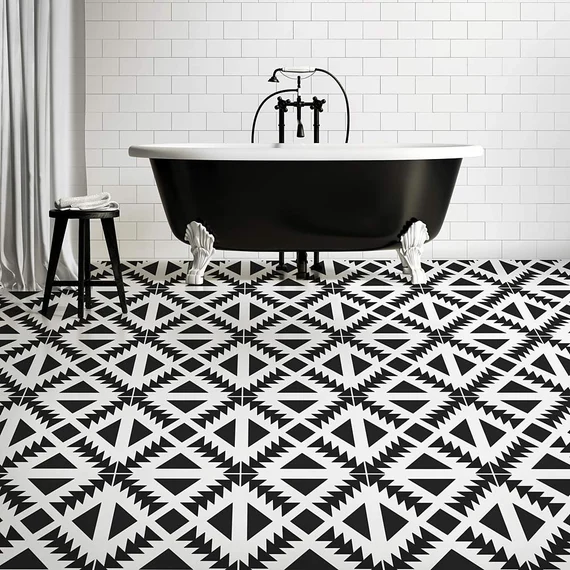 A view of an an aztec black and white bathroom floor with a black tub