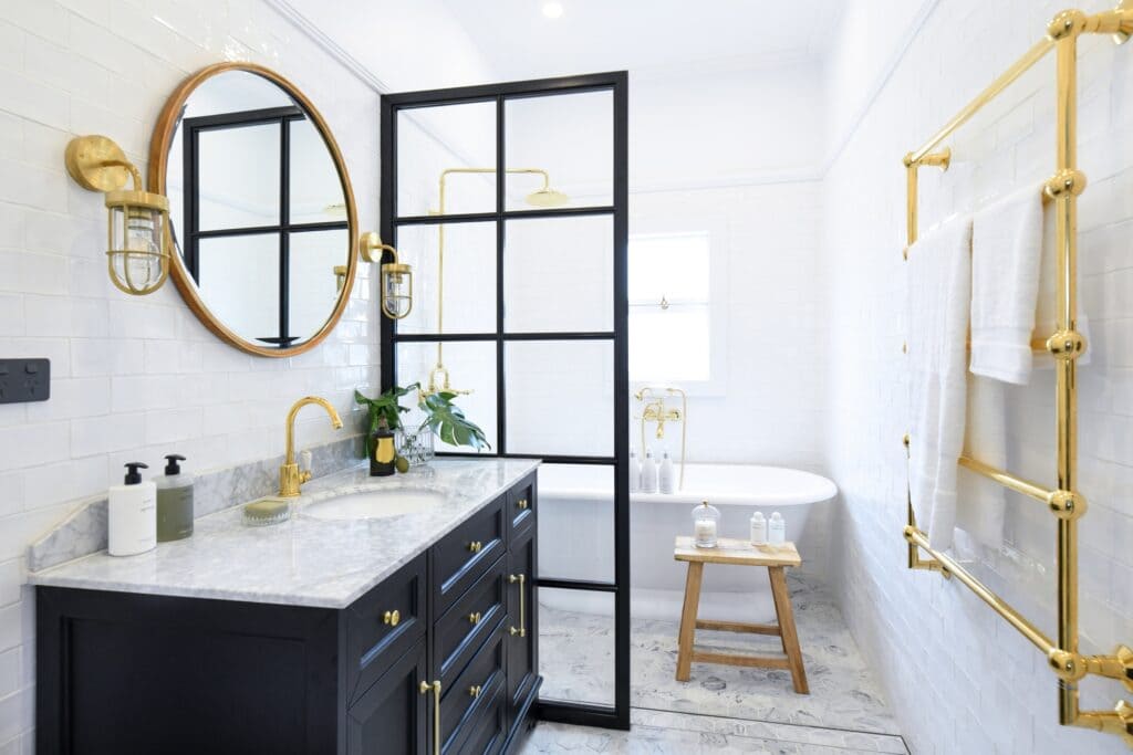 golden accents in black and whtie bathroom mirror layout in gold drawer pullers towel hangers