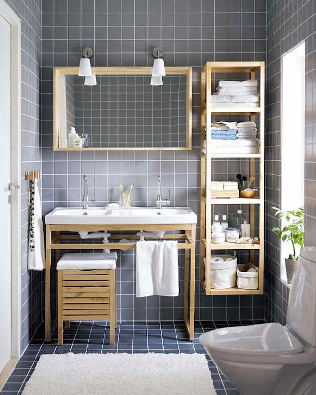 open storage in bathroom toilteries towels shampoos placed in shelves sink with taps