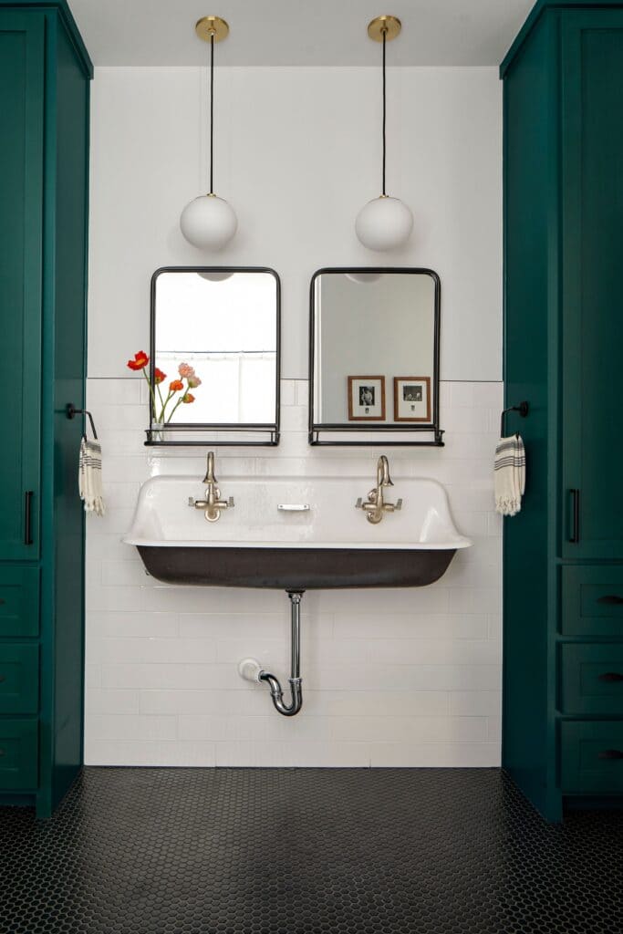 reflective surfaces in a bathroom with mirrors sink with taps lighting fixtures