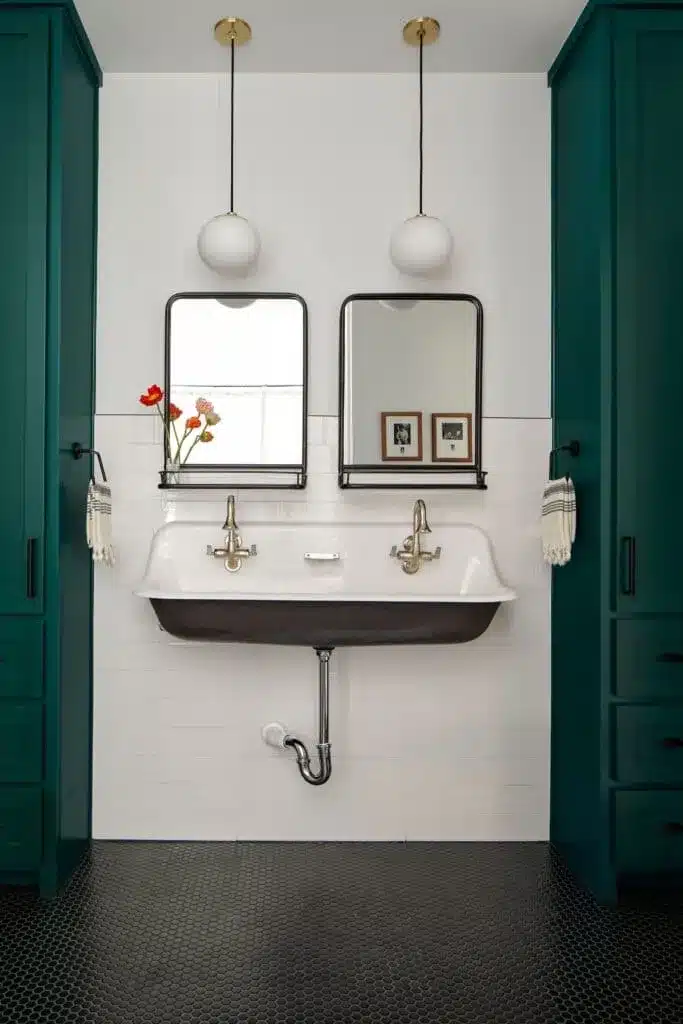 A view of a bathroom-sink with double mirrors attached above it