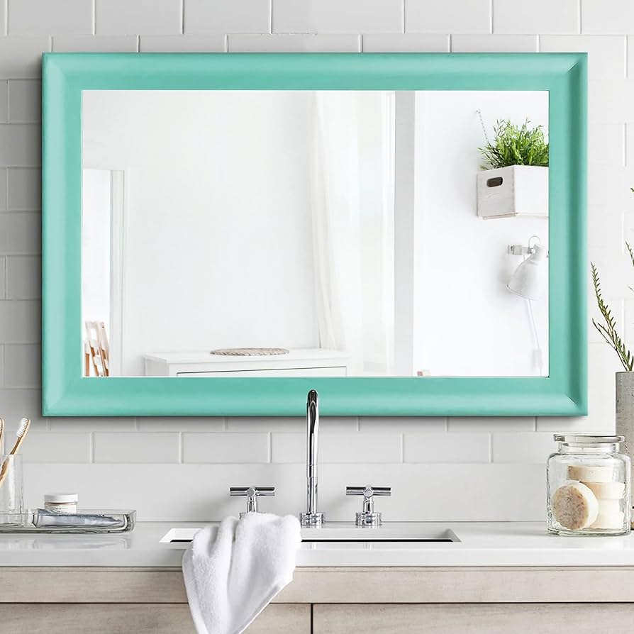 A view of a rectangular green framed mirror