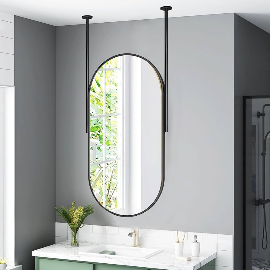 A view of an oval shaped mirror from a bathroom ceiling