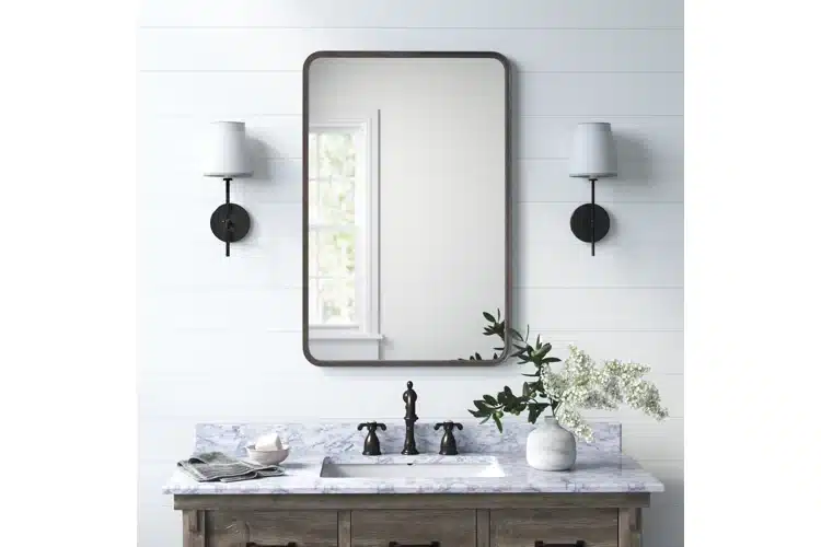 A view of rectangular bathroom mirror over a sink