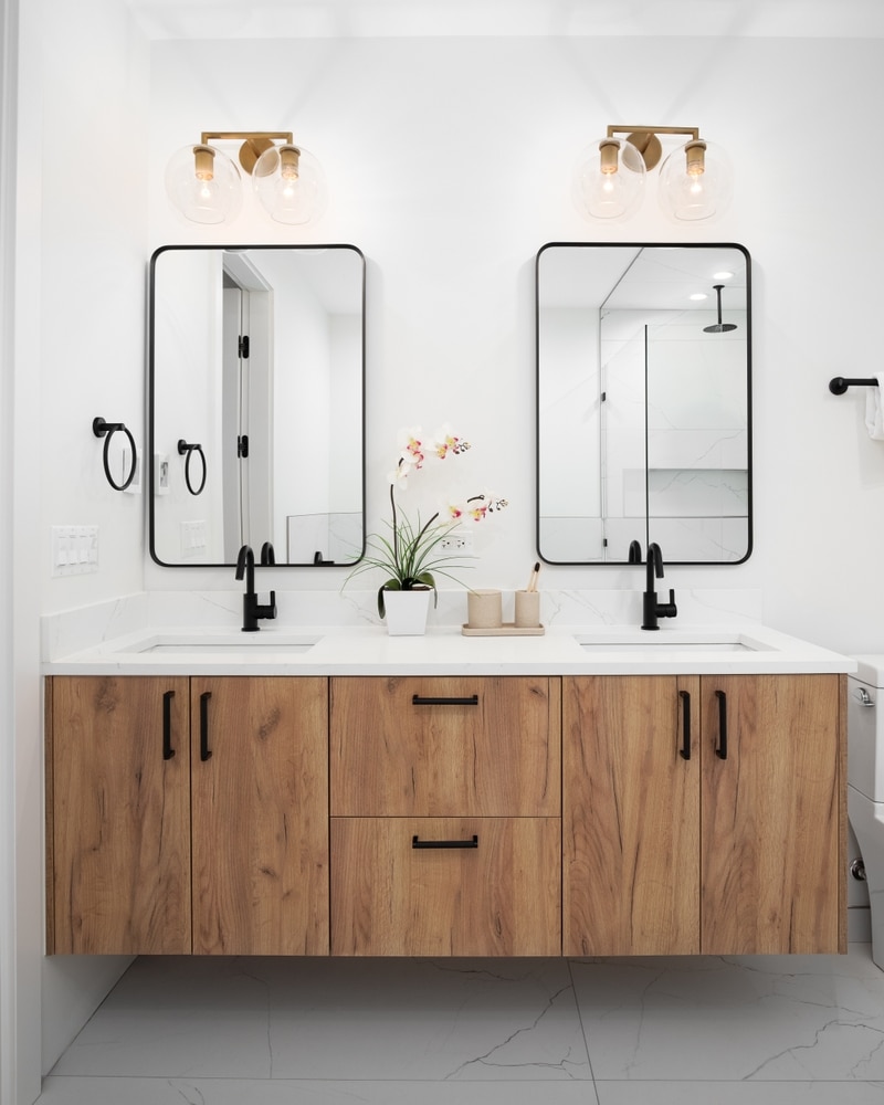 A Bathroom With A Floating Wood Vanity Cabinet Decorations On