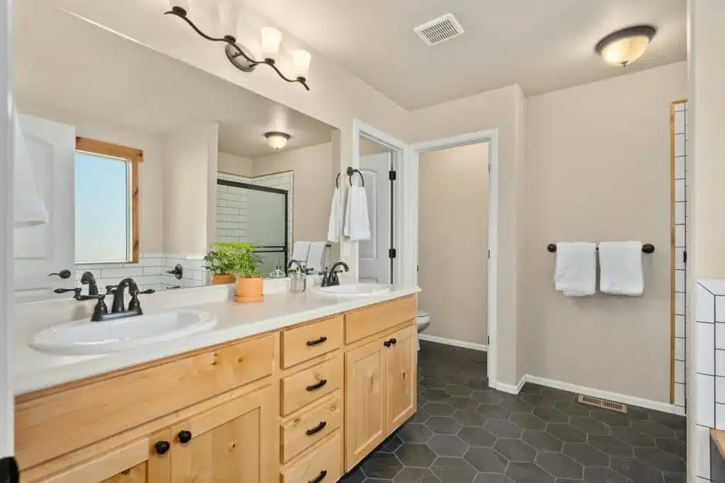 JACK AND JILL BATHROOM WITH wooden vanity light fixtures