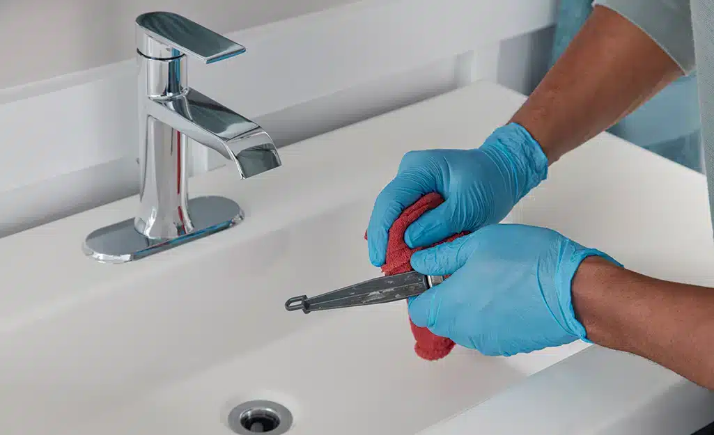 zoomed view of male hand working with sink stopper