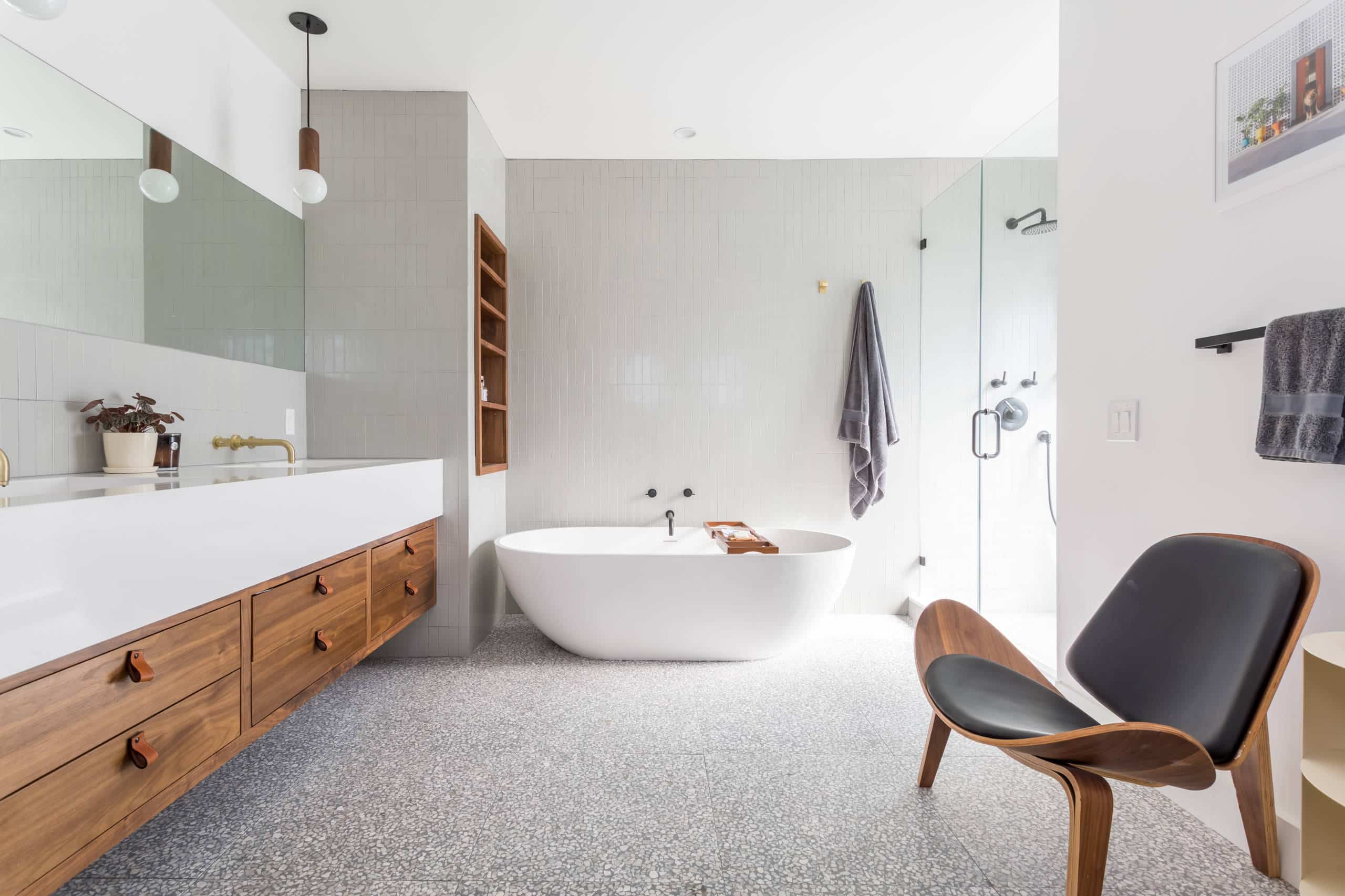 luxury bathroom with terrazo tile on floor wooden vanity a white bathtub