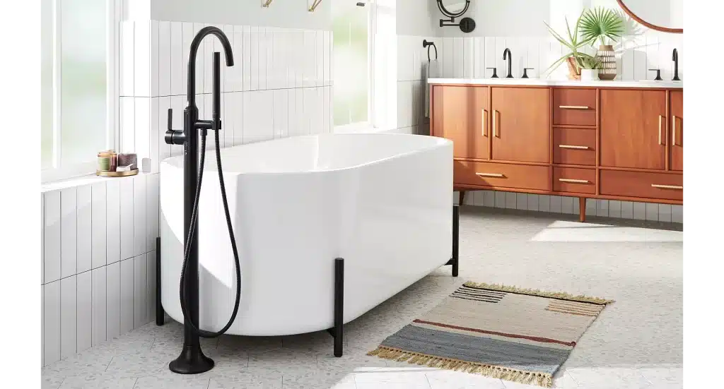 white bathtub with black faucet