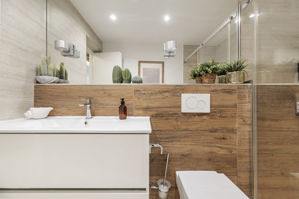 Frontal Image Of A Bathroom With White Furniture Tiled Wall