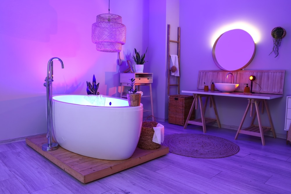 Interior Of Stylish Bathroom With Table Sink And Neon Lighting