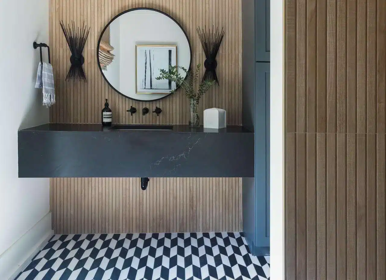 geometric floor in spa bathroom a pot placed along side sink a mirror