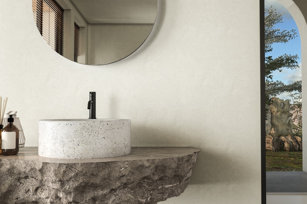 Minimalistic Bathroom Featuring A Natural Stone Countertop With A White