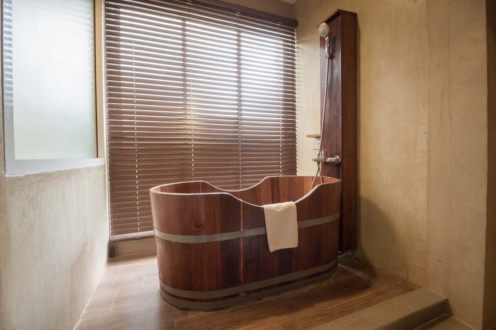 A wooden bathtub in a bathroom interior decoration