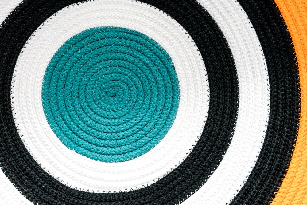 Close Up Circular Pattern Of Colorful Woven Fabric Rug