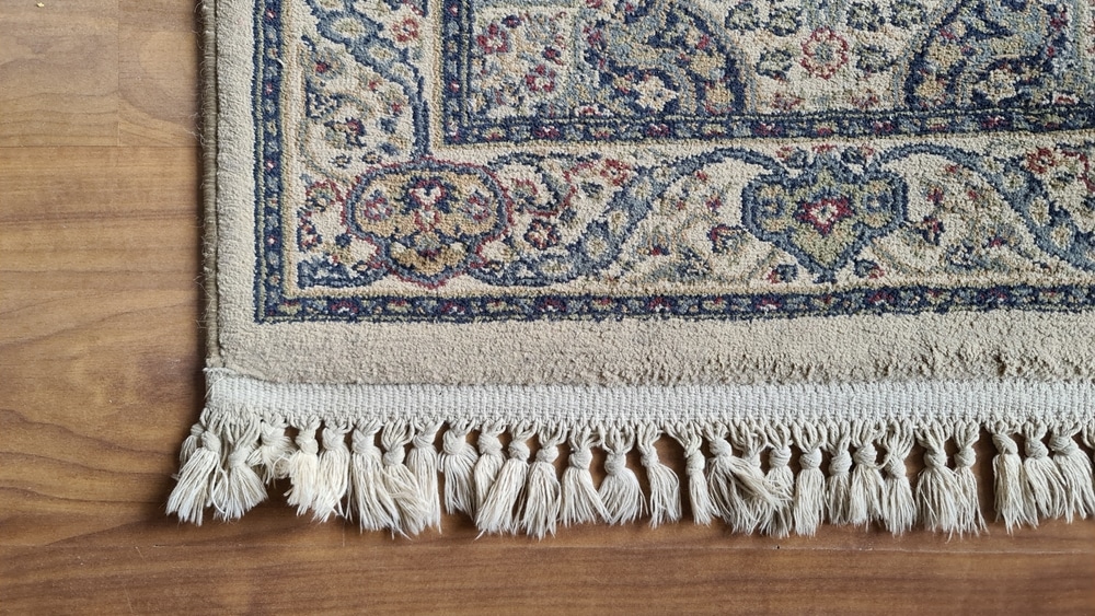 Decorative Oriental Rug With Cotton Fringe On Laminated Wood Flooring